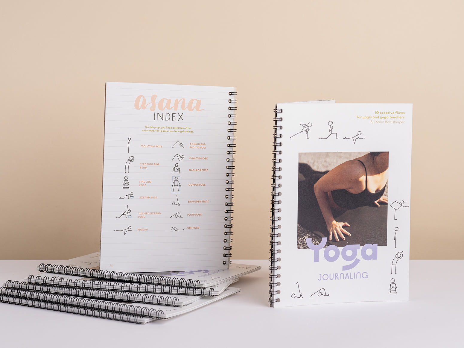 Flat lay of the printed stick figure booklet with yoga props and mat